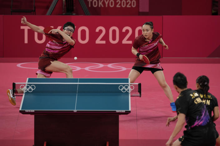 Japan's Mima Ito, left, and Jun Mizutani compete during the table tennis mixed doubles gold medal match against China's Xu Xin and Liu Shiwen at the 2020 Summer Olympics, Monday, July 26, 2021, in Tokyo. (AP Photo/Kin Cheung)