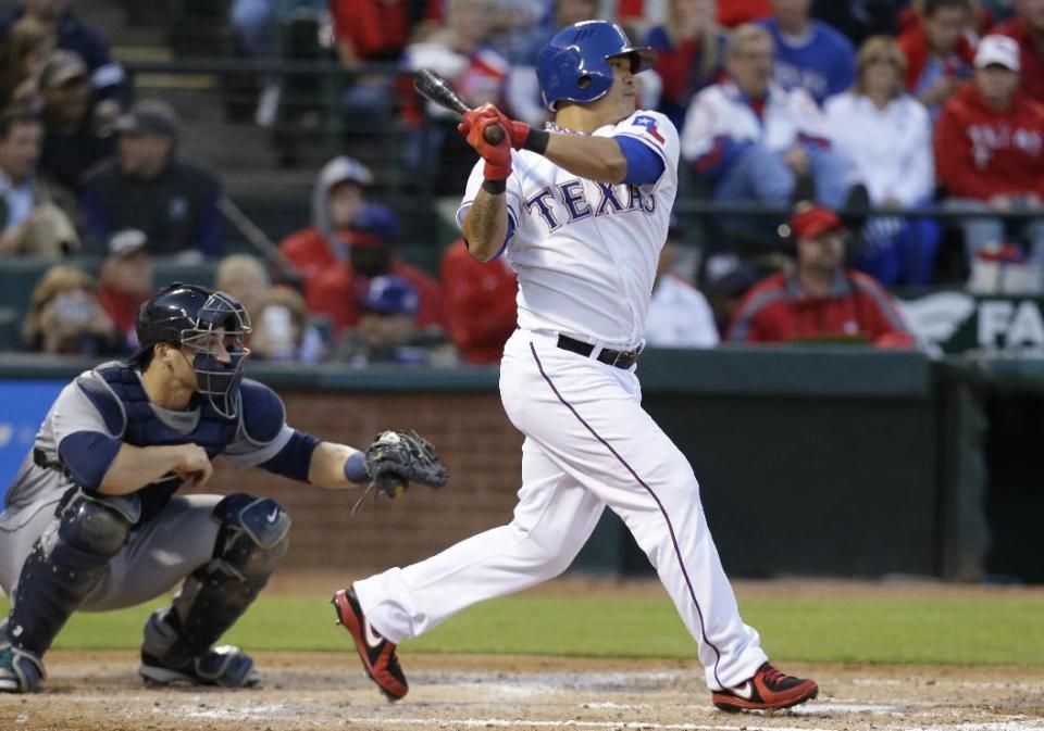 Texas Rangers Shin-Soo Choo, right, of Korea watches his single hit in front of Seattle Mariners catcher Mike Zunino during the third inning of the MLB American League baseball game Tuesday, April 15, 2014, in Arlington, Texas. (AP Photo/LM Otero)