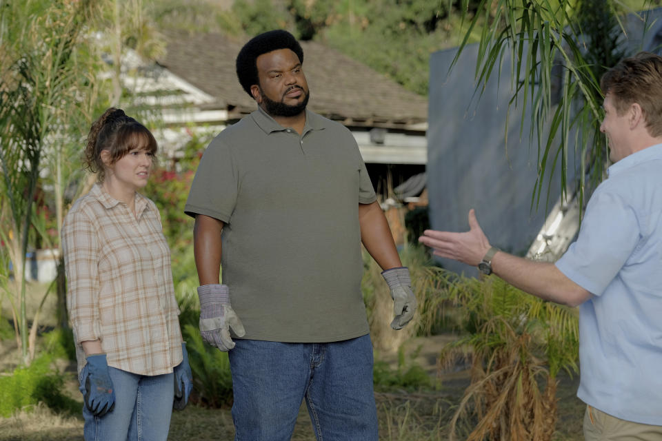 In this photo provided by Peacock, actors Claudia O'Doherty, left, as Jillian, and Craig Robinson, center, as Craig, appear in a scene for season two of "Killing It." (Adam Rose/Peacock via AP)