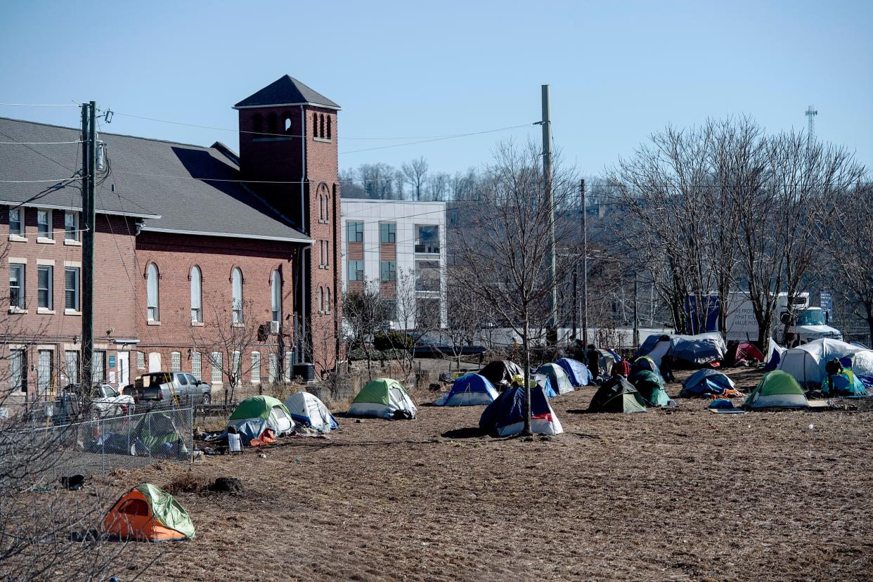 According to officials, the stretch of grass where an encampment has developed along Patton Avenue and I-240 belongs to the North Carolina Department of Transportation.