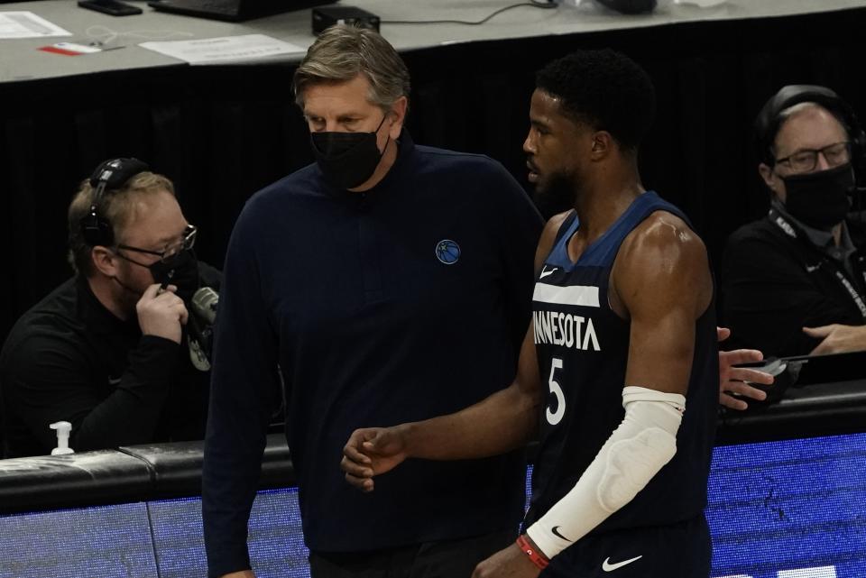 Minnesota Timberwolves head coach Chris Finch talks to Malik Beasley during the first half of an NBA basketball game against the Milwaukee Bucks Tuesday, Feb. 23, 2021, in Milwaukee. (AP Photo/Morry Gash)