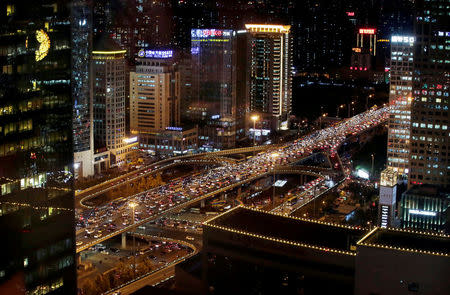 FILE PHOTO - Vehicles are seen through a window as they drive on Guomao Bridge during rush hour in Beijing, China, November 7, 2016. REUTERS/Jason Lee/File Photo