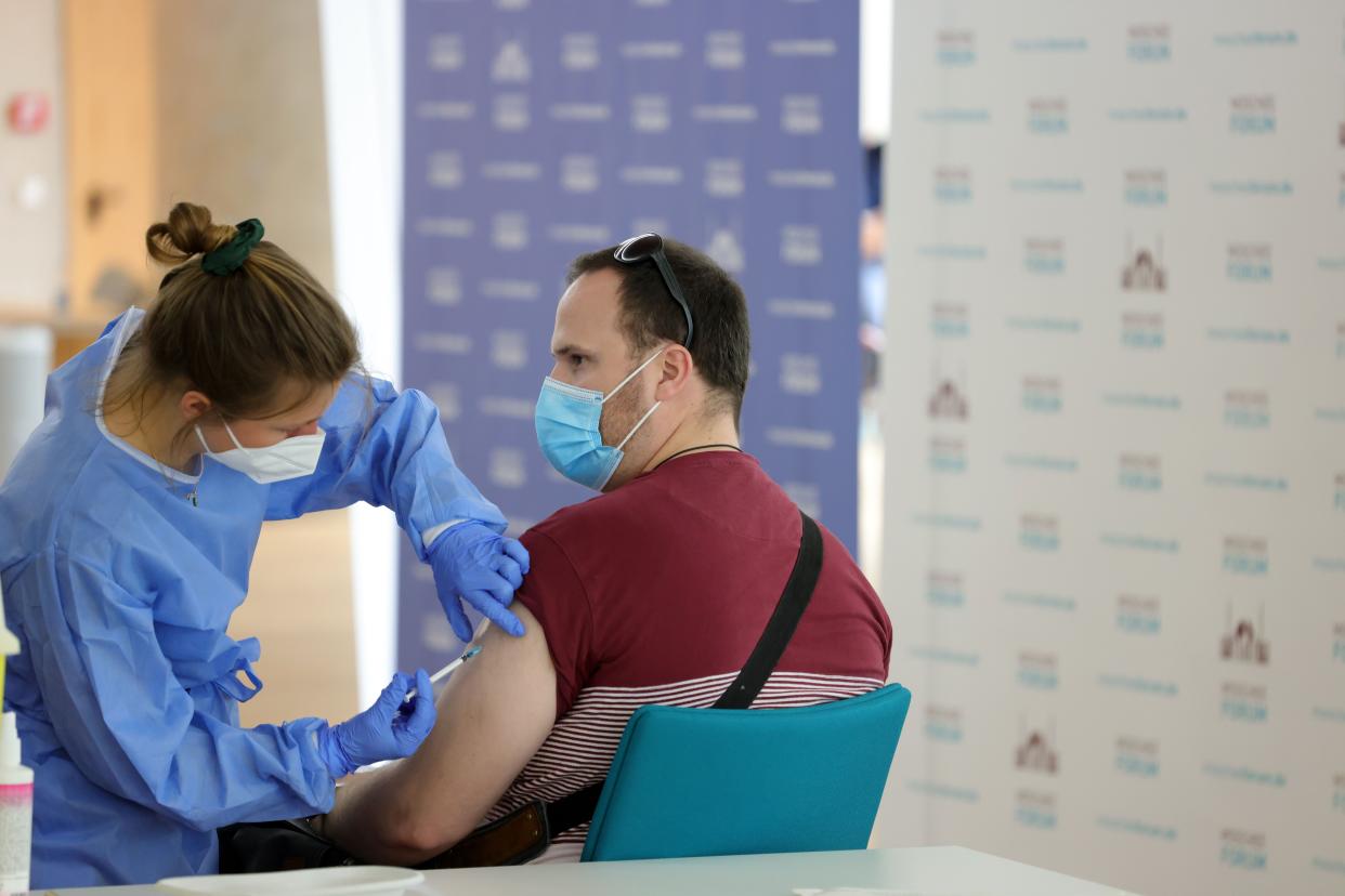 A local resident receives a vaccination with AstraZeneca against COVID-19 inside the city's main mosque, which has temporarily become a mass vaccination center, during the coronavirus pandemic on May 9, 2021, in Cologne, Germany.