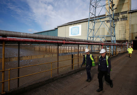 Workers walk at a Tate & Lyle refinery in east London, Britain October 10, 2016. REUTERS/Peter Nicholls