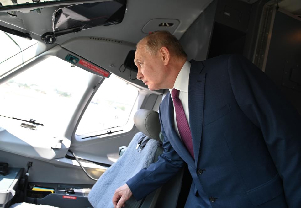 Russian President Vladimir Putin inspects equipment at the MAKS-2021 International Aviation and Space Salon in Zhukovsky outside Moscow, Russia, Tuesday, July 20, 2021. Russia on Tuesday unveiled a prototype of its prospective new fighter jet at the Moscow air show. (Alexei Nikolsky, Sputnik, Kremlin Pool Photo via AP)