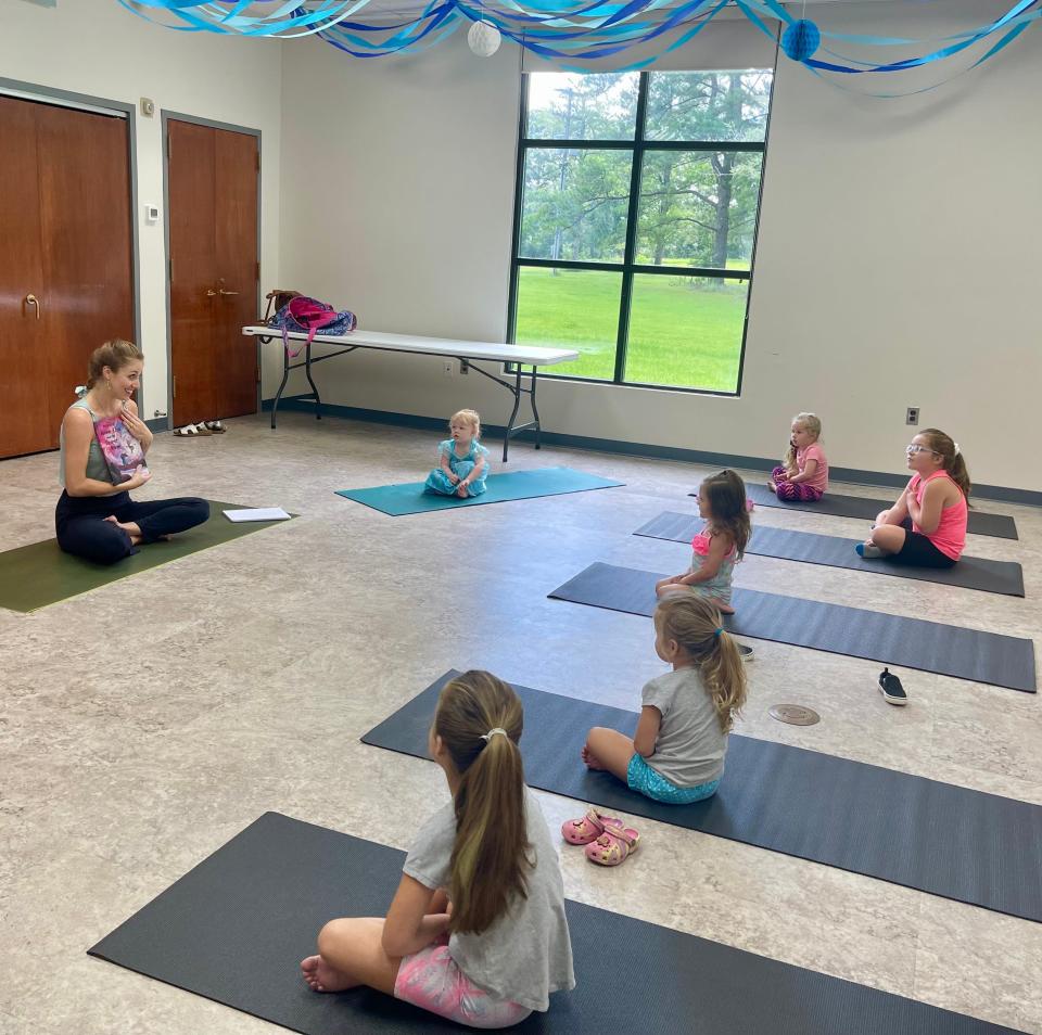 Chloe Wofford, owner and instructor of The Well in Chatom, starts Kiddie Yoga by reading a story to children participating in last summer’s WCPL program on July 6, 2022.