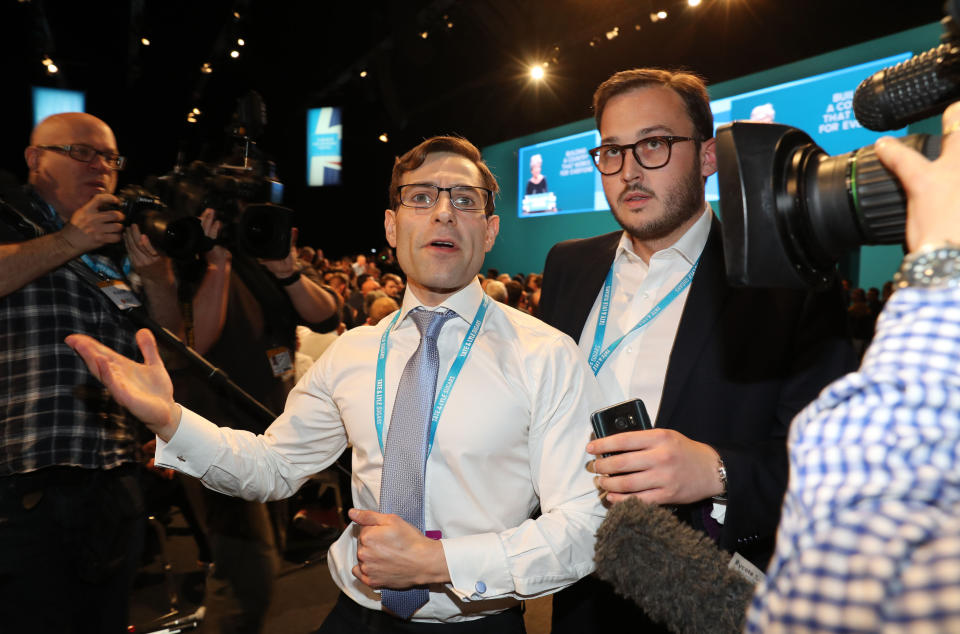 Simon Brodkin, also known as Lee Nelson is led out of the Conservative Party Conference (PA Images)