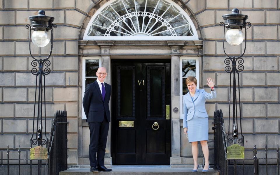 Scotland's First Minister Nicola Sturgeon and Deputy First Minister John Swinney pose for a photo outside Bute House in Edinburgh - POOL/Reuters