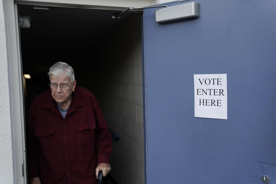 Tom Lanter walks out of the Westwood Public Library after voting on Election Day, Tuesday, Nov. 7, 2023, in Cincinnati. Polls are open in a few states for off-year elections that could give hints of voter sentiment ahead of next year's critical presidential contest. (AP Photo/Joshua A. Bickel)