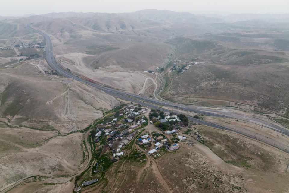 A view of the Bedouin hamlet of Khan al-Ahmar in the West Bank, Tuesday, Jan. 24, 2023. The long-running dispute over the West Bank Bedouin community of Khan al-Ahmar, which lost its last legal protection against demolition four years ago, resurfaced this week as a focus of the frozen Israeli-Palestinian conflict. Israel's new far-right ministers vow to evacuate the village as part of a wider project to expand Israeli presence in the 60% of the West Bank over which the military has full control. Palestinians seek that land for a future state. (AP Photo/Oded Balilty)