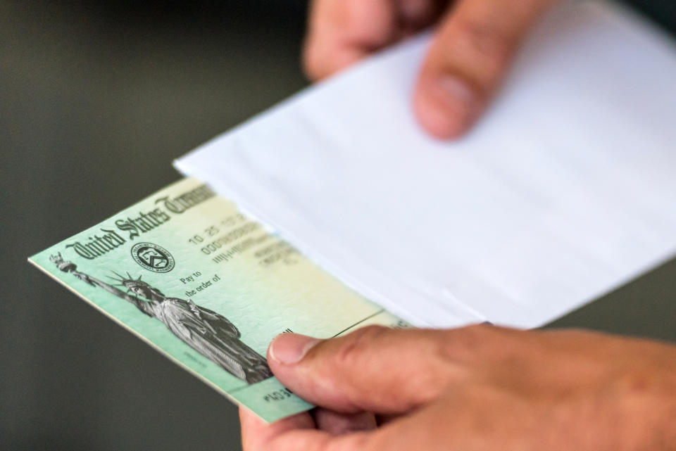 Men hands holding a US Government Treasury check