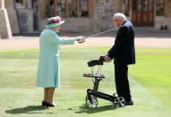 <p>The queen awards Captain Sir Thomas Moore with the insignia of Knight Bachelor at Windsor Castle. British World War II veteran Captain Tom Moore raised over $38 million for the NHS during the coronavirus pandemic. </p>