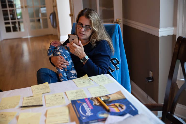 May 1: Stamford, Connecticut elementary school teacher Luciana Lira teaches remotely from her home while caring for a student’s one-month-old brother after his family contracted the virus. (Getty Images)