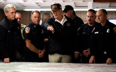 President Trump is briefed by emergency workers at an operations centre in Chico, California - Credit: Evan Vucci/AP