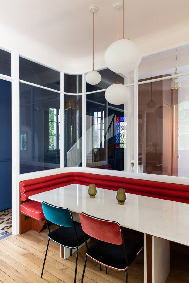 Pendant lamps hanging above dining table in newly renovated dining room.