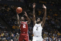 Oklahoma guard Umoja Gibson (2) shoots as West Virginia guard Kobe Johnson (2) defends during the first half of an NCAA college basketball game in Morgantown, W.Va., Wednesday, Jan. 26, 2022. (AP Photo/Kathleen Batten)