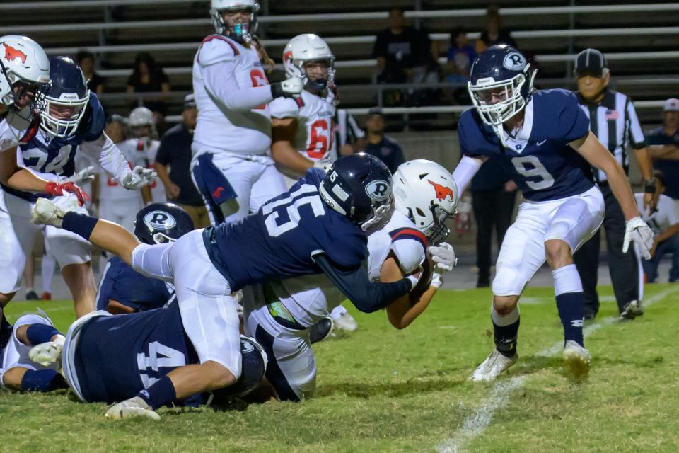 Redwood's Alec Harrold makes a tackle against Tulare Western in a non-league high school football game at Mineral King Bowl on September 8, 2023.