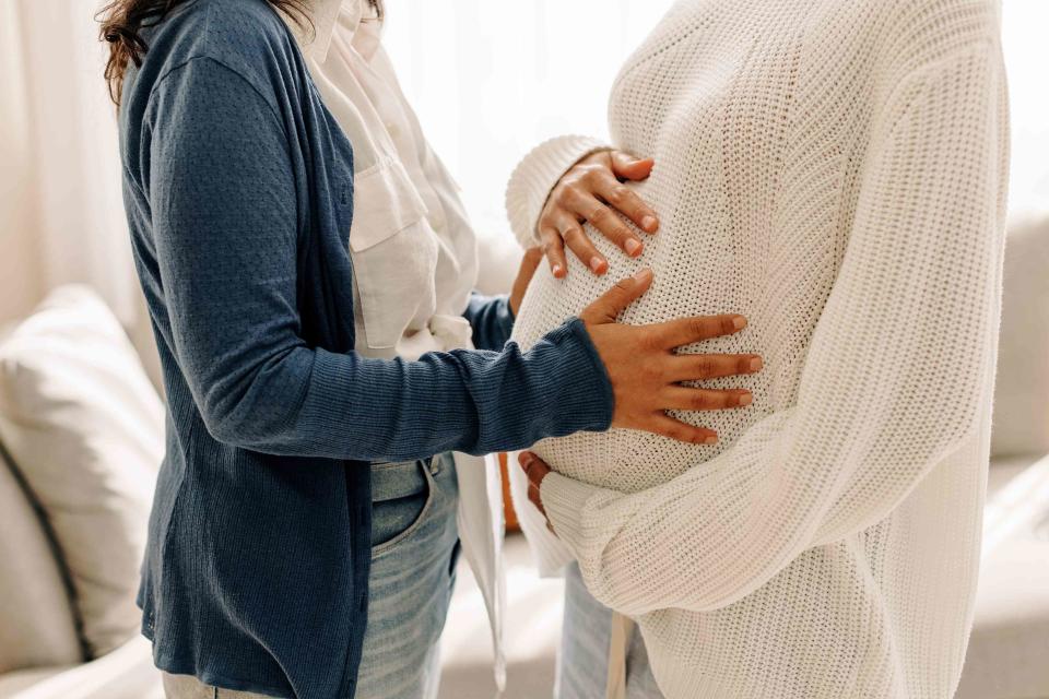 <p>Getty	</p> Woman touching the belly of a pregnant woman in a stock photo