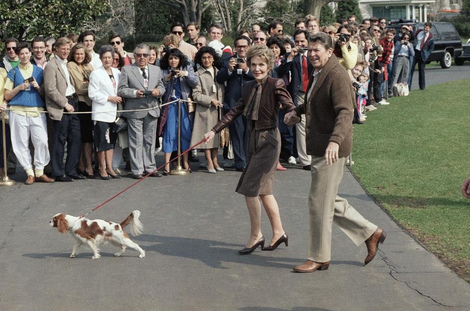 President Ronald Reagan and first lady Nancy Reagan walk with their dog Rex in 1986.