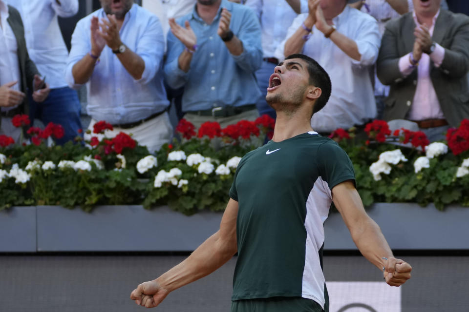 Carlos Alcaraz, of Spain, celebrates after winning the final match against Alexander Zverev, of Germany, at the Mutua Madrid Open tennis tournament in Madrid, Spain, Sunday, May 8, 2022. (AP Photo/Paul White)