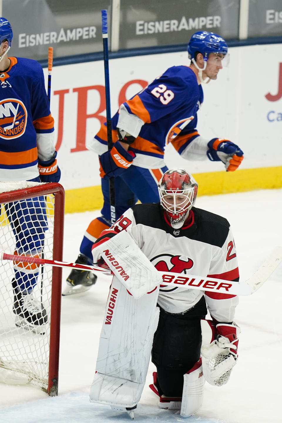 New Jersey Devils goaltender Mackenzie Blackwood (29) reacts as New York Islanders' Brock Nelson (29) skates toward his bench after scoring a goal during the second period of an NHL hockey game Saturday, May 8, 2021, in Uniondale, N.Y. (AP Photo/Frank Franklin II)