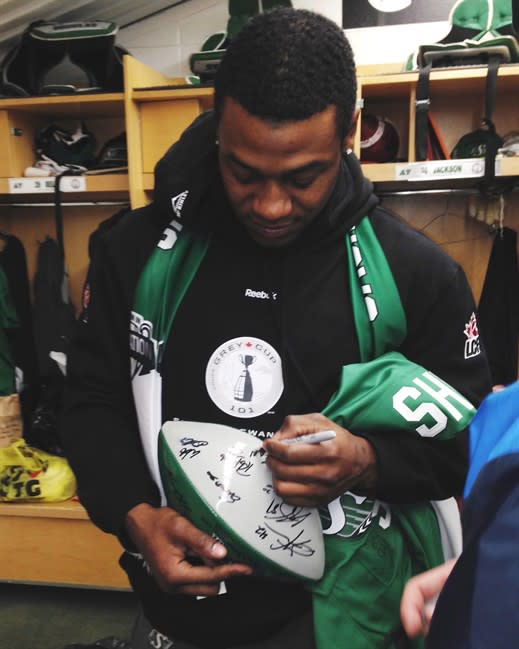 Running back Kory Sheets signs autographs for teammates as the Saskatchewan Roughriders clean out their lockers at Mosaic Stadium in Regina on Tuesday, November 26, 2013. The Riders won the Grey Cup Sunday over the Hamilton Tiger-Cats. THE CANADIAN PRESS/Jennifer Graham