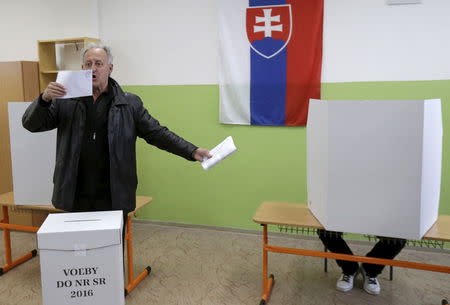 A voter reacts before casting his ballot at a polling station during the country's parliamentary election in Trnava, Slovakia, March 5, 2016. REUTERS/David W Cerny