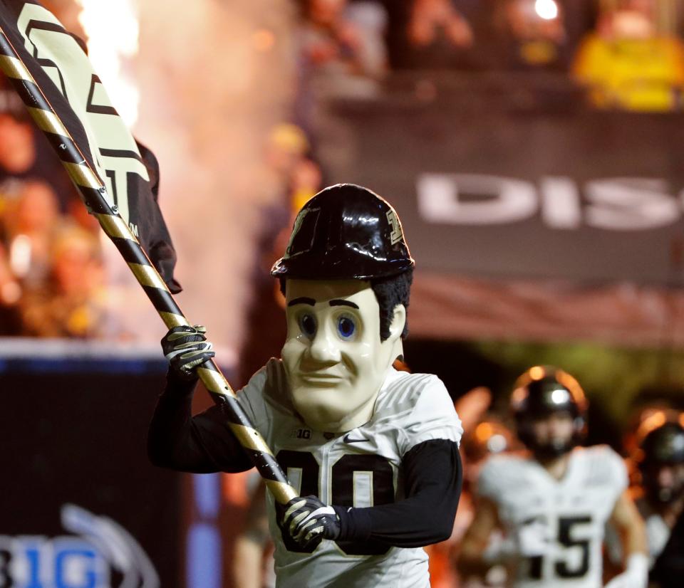 Purdue Pete leads the <a class="link " href="https://sports.yahoo.com/ncaaw/teams/purdue/" data-i13n="sec:content-canvas;subsec:anchor_text;elm:context_link" data-ylk="slk:Purdue Boilermakers;sec:content-canvas;subsec:anchor_text;elm:context_link;itc:0">Purdue Boilermakers</a> onto the field during the Big Ten football championship against the <a class="link " href="https://sports.yahoo.com/ncaaw/teams/michigan/" data-i13n="sec:content-canvas;subsec:anchor_text;elm:context_link" data-ylk="slk:Michigan Wolverines;sec:content-canvas;subsec:anchor_text;elm:context_link;itc:0">Michigan Wolverines</a> on Saturday, Dec. 3, 2022 at Lucas Oil Stadium in Indianapolis. Michigan Wolverines leads at the half against the Purdue Boilermakers, 14-13.