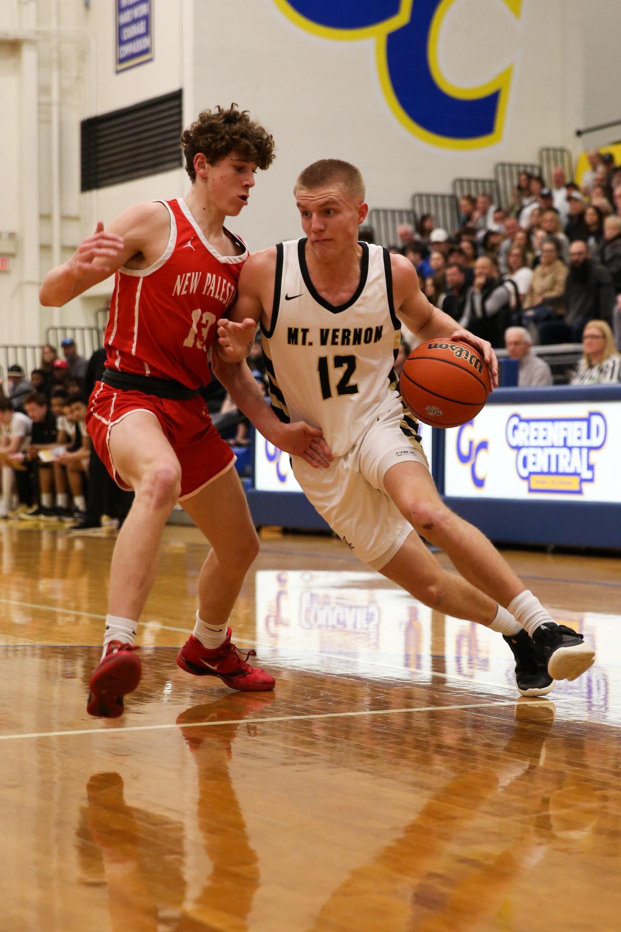 Mt. Vernon Luke Ertel (12) attempts to get around New Palestine Austin Mcmahan (13) as New Palestine plays Mt. Vernon High School in the IHSAA Class 4A Boys Basketball S9 Sectional, Feb 27, 2024; Greenfield, IN, USA; at Greenfield-Central High School.