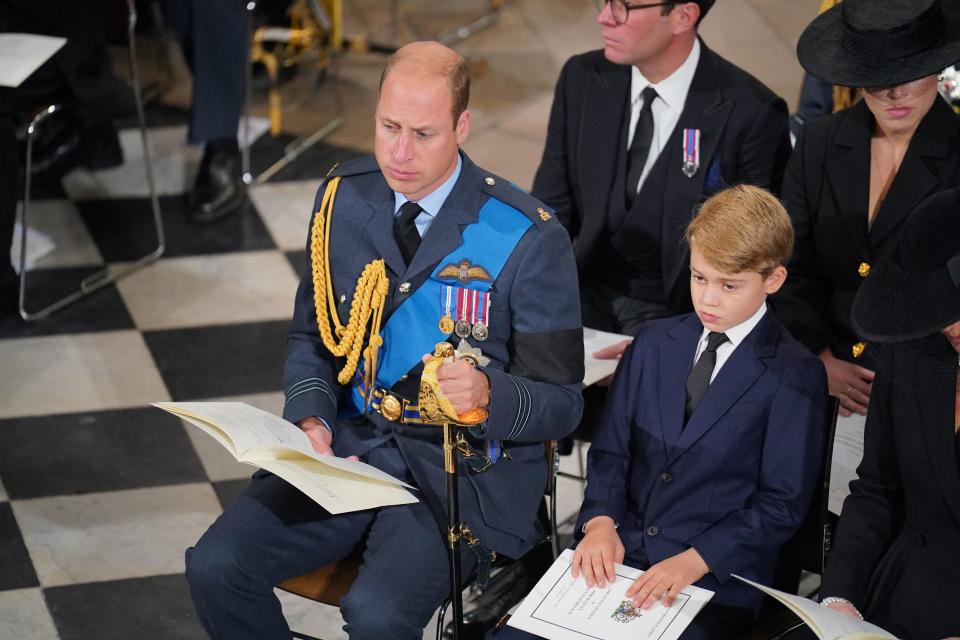 Prince William, Prince of Wales, and his son, Prince George of Wales, take their seats inside Westminster Abbey in London on Sept. 19, 2022, for the funeral of Queen Elizabeth II.