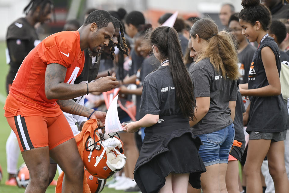 Cleveland Browns quarterback Deshaun Watson signs autographs after an NFL football practice at the team's training facility, Wednesday, June 1, 2022, in Berea, Ohio. (AP Photo/David Richard)