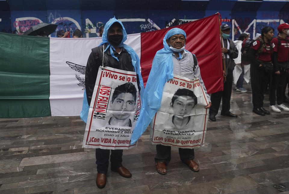 Family members and friends march seeking justice for the missing 43 Ayotzinapa students in Mexico City, Friday, Aug. 26, 2022. Six of the 43 college students "disappeared" in 2014 were allegedly kept alive in a warehouse for days then turned over to the local army commander who ordered them killed, the Mexican government official leading a Truth Commission said Friday. (AP Photo/Marco Ugarte)