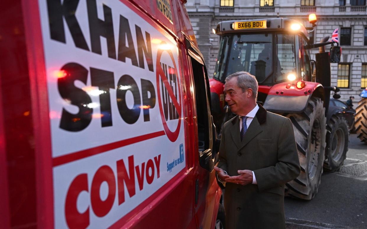 Nigel Farage speaks to the driver of a van taking part in a protest against the ULEZ charge