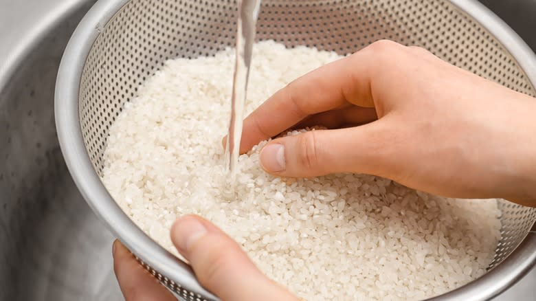 Rinsing rice in colander