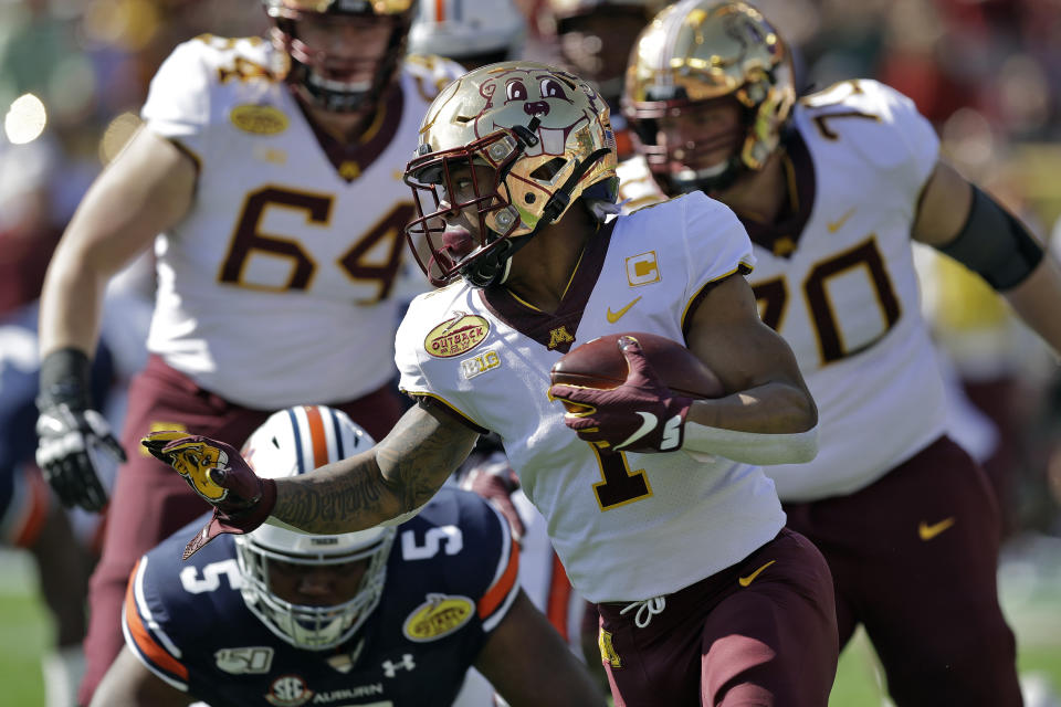 Minnesota running back Rodney Smith (1) runs past Auburn defensive tackle Derrick Brown (5) during the first half of the Outback Bowl NCAA college football game Wednesday, Jan. 1, 2020, in Tampa, Fla. (AP Photo/Chris O'Meara)