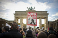 Demonstrators attend a protest against the death of Iranian Mahsa Amini in Berlin, Germany, Wednesday, Sept. 28, 2022. Amini, a 22-year-old woman who died in Iran while in police custody, was arrested by Iran's morality police for allegedly violating its strictly-enforced dress code. (Kay Nietfeld/dpa via AP)