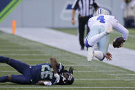 Dallas Cowboys quarterback Dak Prescott (4) goes airborne after a tackle by Seattle Seahawks cornerback Shaquill Griffin (26) during the second half of an NFL football game, Sunday, Sept. 27, 2020, in Seattle. The Seahawks won 38-31. (AP Photo/John Froschauer)