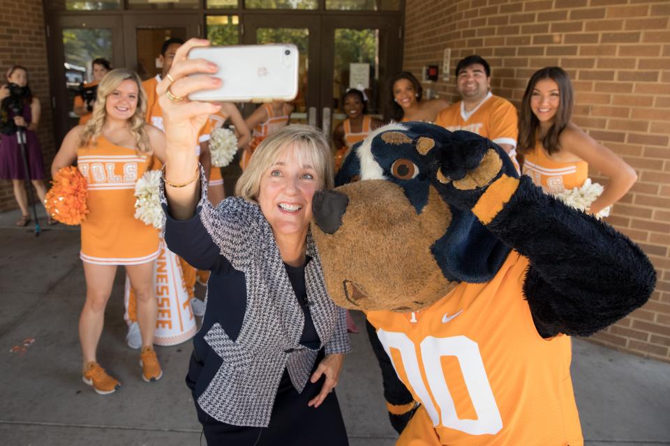 Chancellor Donde Plowman poses for a selfie with Smokey and the UT Cheerleaders before surprising West High School students with acceptance letters on Sept. 12, 2019.