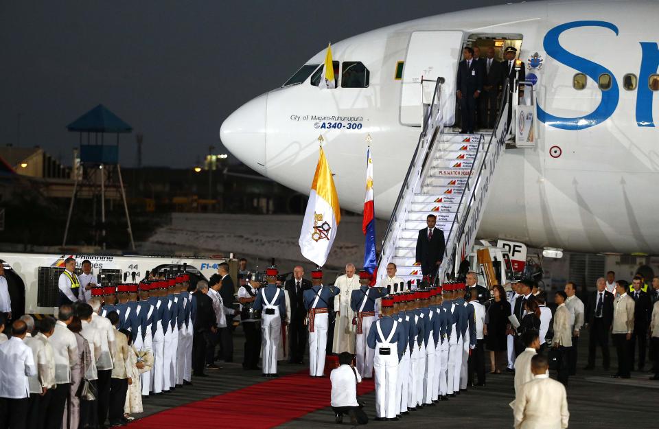 Pope Francis and President Aquino listen to national anthems at the Villamor Air Base in Manila