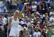 Maria Sharapova of Russia celebrates after winning her match against Irina-Camelia Begu of Romania at the Wimbledon Tennis Championships in London, July 3, 2015. REUTERS/Toby Melville