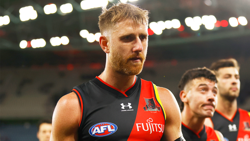 Essendon captain Dyson Heppell (pictured) walking off the field.