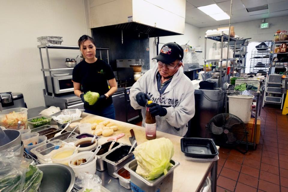 Anna Le Nguyen, and Minh Rasavong Oriyavong help out in the kitchen of "Love & Thai" in Fresno, Calif. on Wednesday, Dec. 20, 2023.