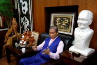 Chang An-lo, known as "White wolf", leader of the Chinese Unification Promotion Party (CUPP), sits next to a bust of China's late leader Deng Xiaoping during an interview in Taipei