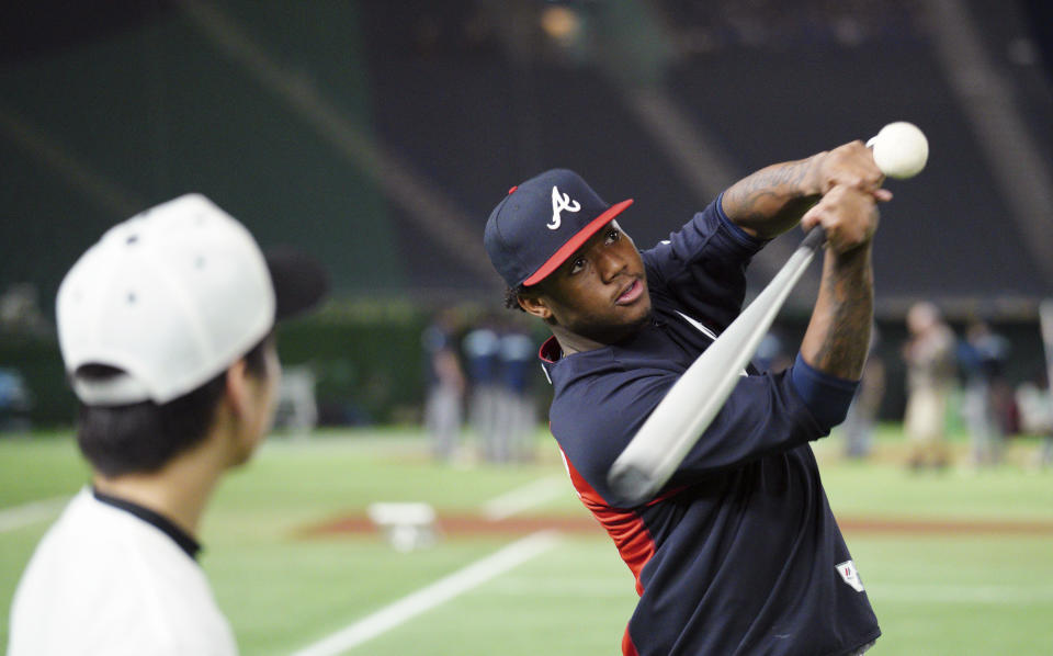 MLB All-Star Atlanta Braves' Ronald Acuna Jr. hits a ball to Japanese junior high school students during MLB All Stars Baseball clinic as part of All-Stars Series baseball games at Tokyo Dome in Tokyo Saturday, Nov. 10, 2018. (AP Photo/Eugene Hoshiko)