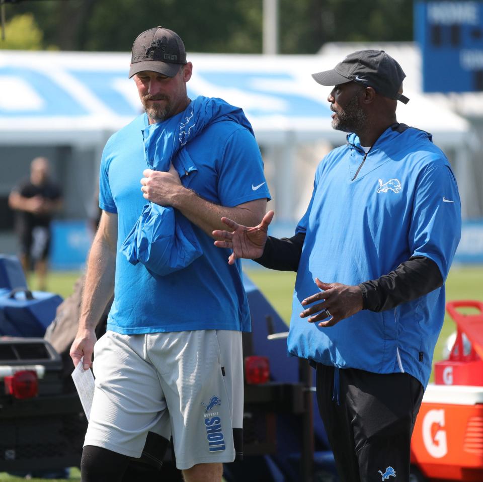 Lions GM Brad Holmes (right) and coach Dan Campbell talk after training camp in Allen Park on Thursday, July 29, 2021.
