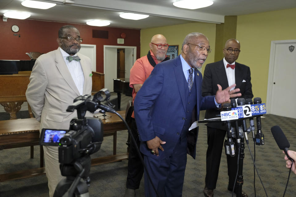 African American leaders from left, Rev. Arnold Townsend, artist Dewey Crumpler, Dr. Amos Brown, local NAACP president, gesturing, and columnist Noah Griffin voice their support for keeping the controversial mural at Washington High School during a news conference Tuesday, Aug. 6, 2019, in San Francisco. The controversial 13-panel, 1,600-square foot mural, the "Life of Washington," criticized as racist and degrading for its depiction of black and Native American people, is slated to be destroyed after the San Francisco School Board voted last month to paint over it. (AP Photo/Eric Risberg)