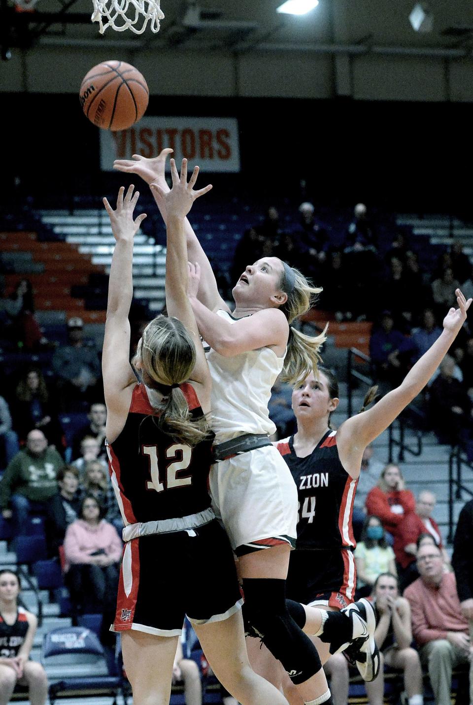 Lincoln Community High School's Kloe Froebe goes up for a shot during the game against Mt. Zion High School Tuesday Feb. 21, 2023.