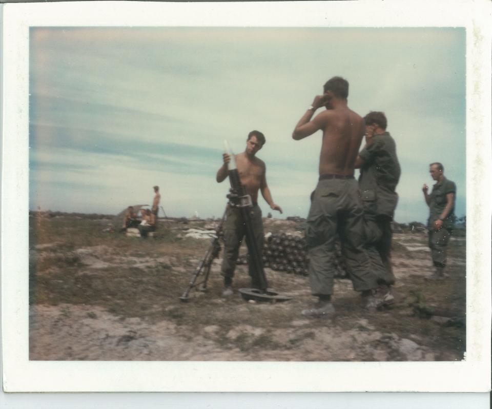 Dick Wolfe drops a shell into a mortar tube two days before he was killed in Vietnam.