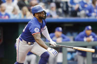 Texas Rangers Adolis García hits an RBI single during the fourth inning of a baseball game against the Kansas City Royals in Kansas City, Mo., Saturday, May 4, 2024. (AP Photo/Colin E. Braley)