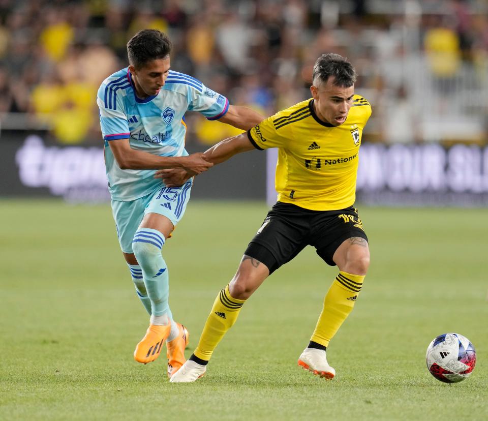 May 31, 2023; Columbus, Oh., USA; Columbus Crew midfielder Lucas Zelarayan (10) is held by Colorado Rapids midfielder Danny Leyva (15) during the second half of Wednesday's match at Lower.com Field. Mandatory Credit: Barbara J. Perenic/The Columbus Dispatch